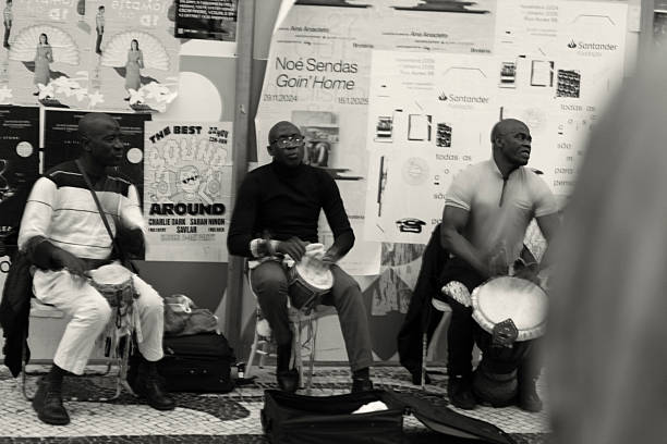 Lisbon, Portugal - November 30, 2024: A trio of street musicians play percussion at the Rua Augusta street in Lisbon downtown.