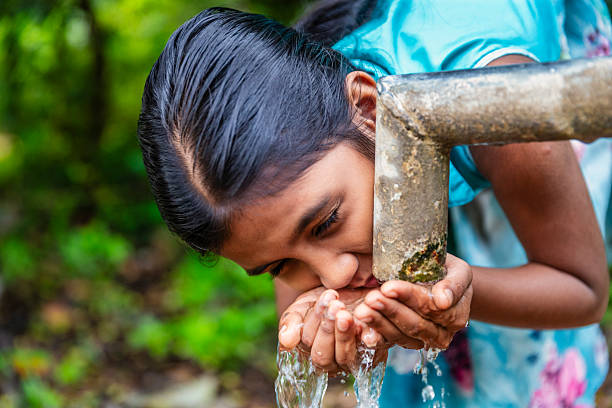 istock Sri Lankan young girl drinking a water, Ceylon 2215030936