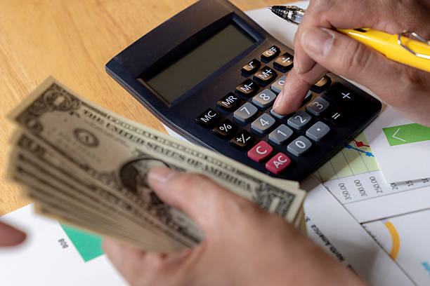 istock Partial view of hands using a calculator and writing down expenses, concept of personal finance management 2215031471