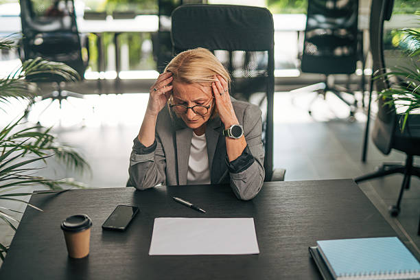 istock Stressed businesswoman having headache at work 2215031860