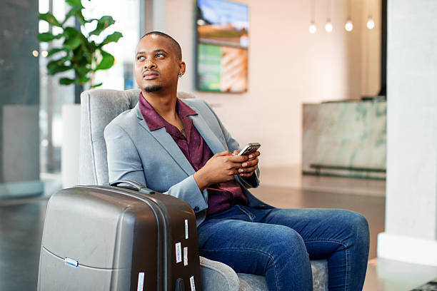 istock Businessman using a smart phone in a Hotel lobby 2215032305