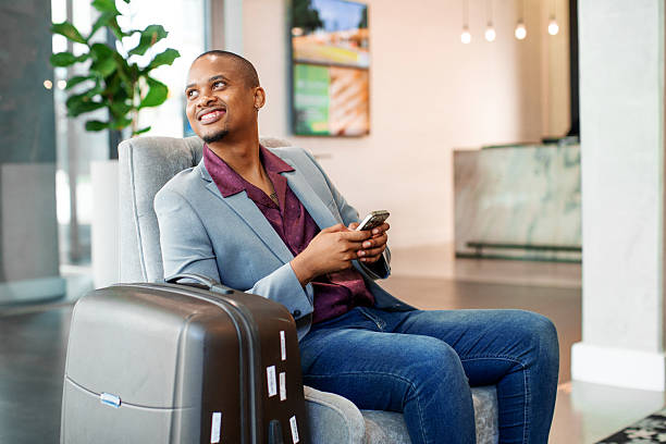 istock Businessman using a smart phone in a Hotel lobby 2215032309