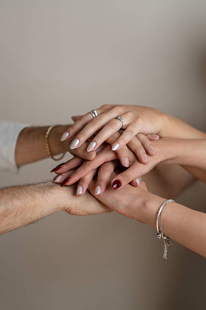 istock Close-up of Group of Hands Stacked Together Showing Unity and Support 2215035364