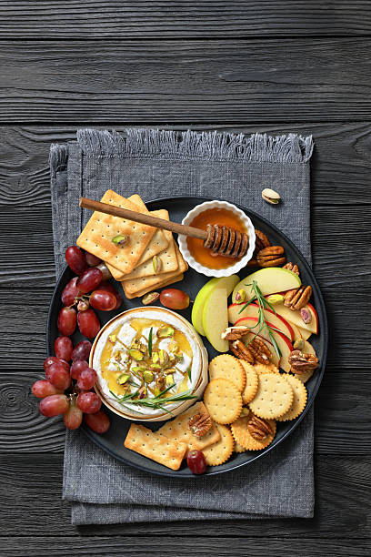 istock Baked Camembert with honey, pistachios, top view 2215035661