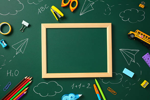istock Back to school concept. Blank chalkboard with frame surrounded by colorful school supplies 2215035762