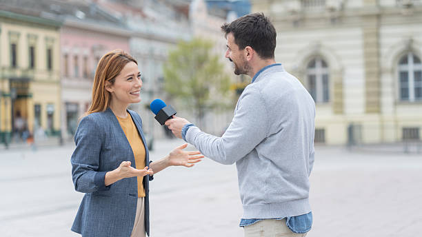 istock Engaging outdoor interview in a lively urban setting. 2215037119