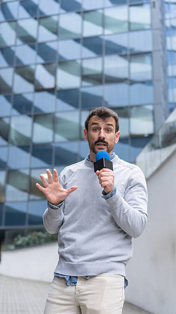 istock Man gestures while passionately delivering a news report 2215037123