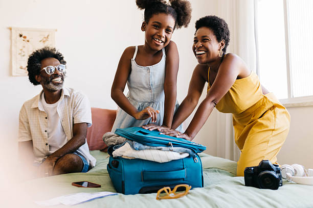 istock Excited family packing a suitcase for a fun vacation 2215037253