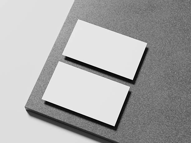 istock Elegant white business card placed on a sleek marble surface, with a soft shadow enhancing its modern design. 2215039754