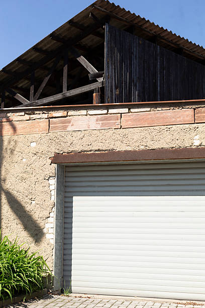 istock A rustic garage with a weathered roof and appealing surrounding greenery 2215042606