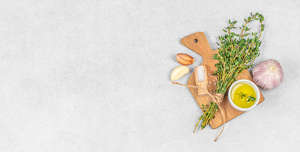 istock cooking background Spices herbs bunch thyme and seasoning on stone light background, top view. copy space 2215044213
