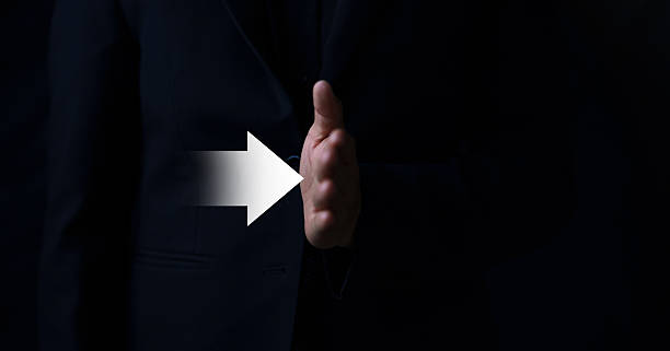 Hand gesture signaling agreement indoor setting digital content dark background close-up view conceptual communication