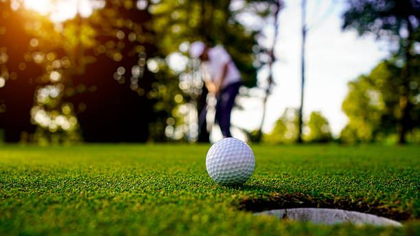 istock Golfers are putting golf in the evening golf course golf backglound. 2215051866
