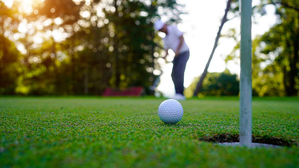 istock Golfers are putting golf in the evening golf course golf backglound. 2215051895