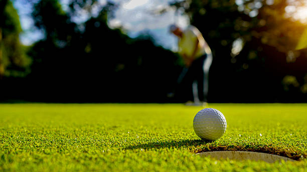 istock Golfers are putting golf in the evening golf course golf backglound. 2215051910