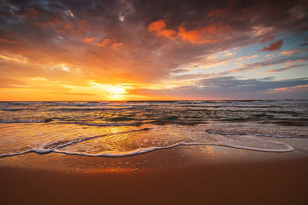 istock Beautiful sunrise over the sea shore and ocean waves 2215052182