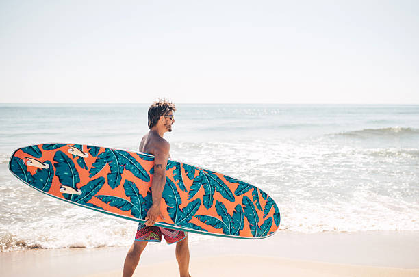 istock Happy surfer on the beach in a sunny day. 2215055182