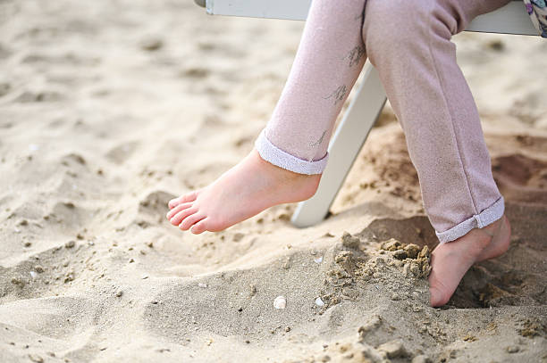 Woman’s foot in white sand in the Mexican Caribbean