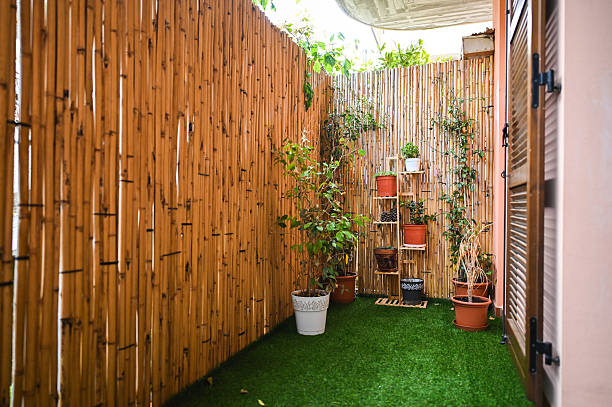 istock Small cozy garden with bamboo fence and artificial grass 2215058566
