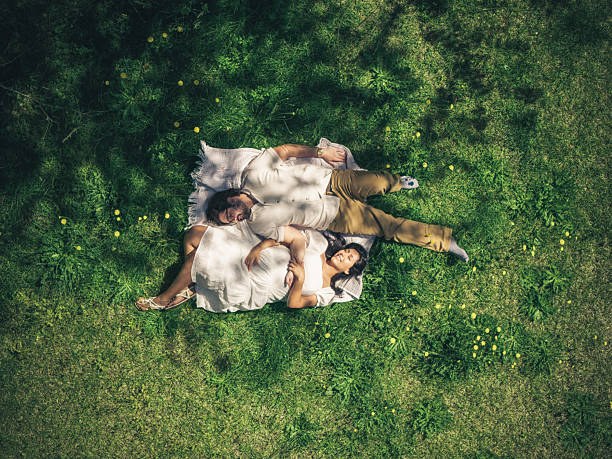 istock Happy Mexican Couple Expecting a Baby - Third Trimester - Back Yard Top Down 2215059469