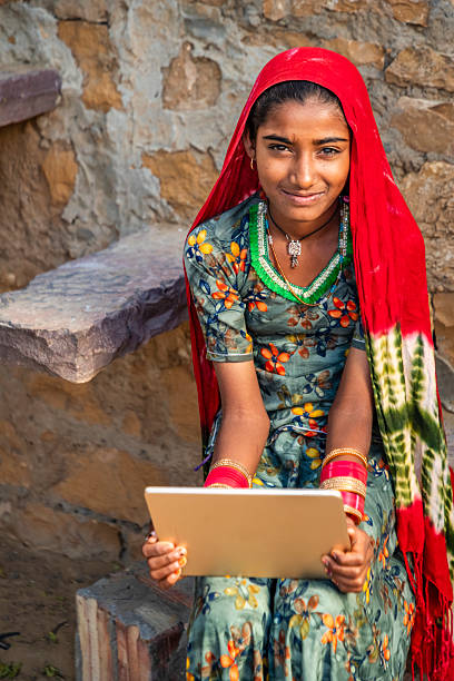 istock Happy Indian girl using a digital tablet, India 2215059575