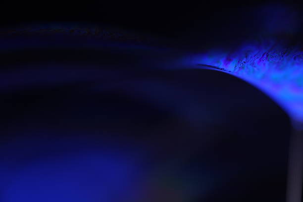 istock Deep purple liquid surface on black background, oil stains movement, bright chemistry, surreal background, deep galaxy atmosphere 2215061441