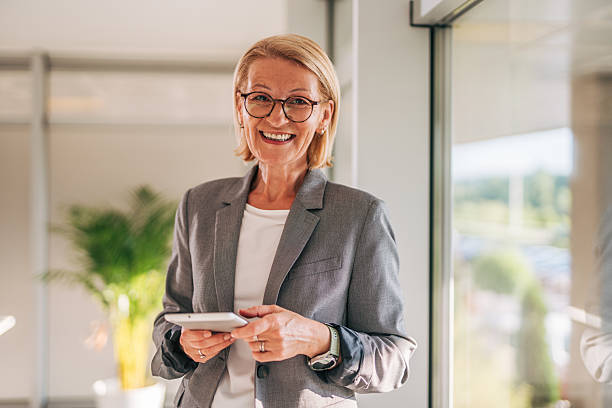 istock Smiling senior businesswoman using digital tablet in office 2215062673