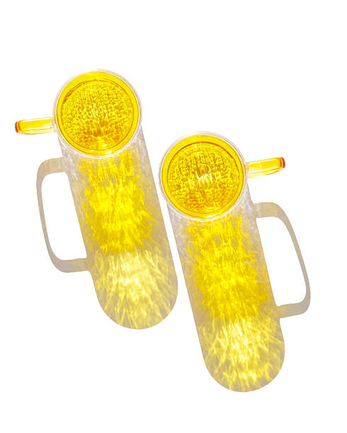 Two Yellow colored glass cup with artistic light reflections, shadows and caustics isolated on white background. Clear mug for tea and coffee at sunlight, summer drink design elements minimal trend