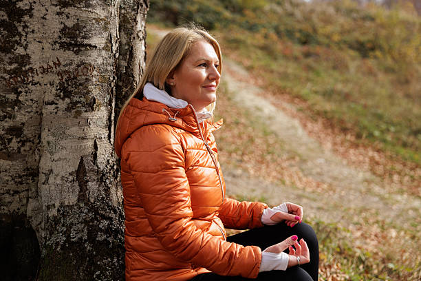 istock Woman Meditates Peacefully in Autumn Forest Setting 2215062998