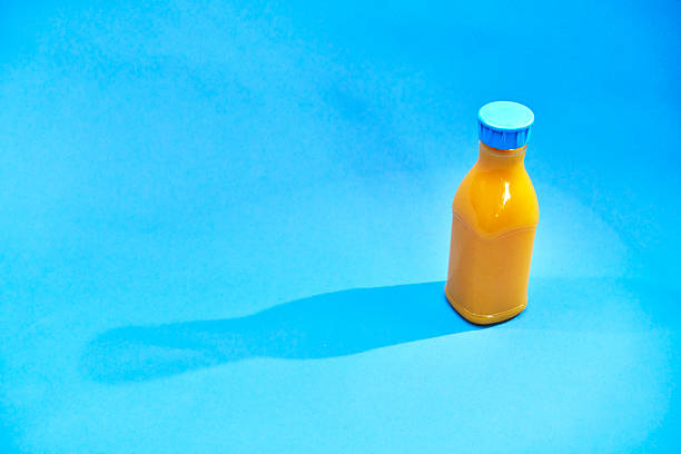 Orange Juice in Recycled PET Plastic Bottle on Blue Background
