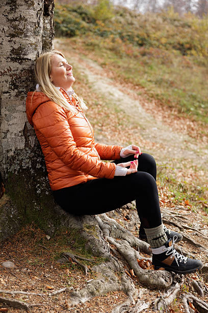 istock Woman Meditates Peacefully in Autumn Forest Setting 2215064564