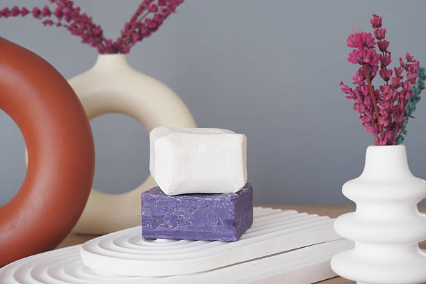 Minimalist Display of White and Purple Soap Bars on a Ceramic Tray