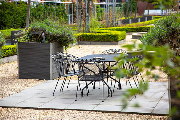 istock Empty black metal chairs and table standing on a terrace in a beautiful garden 2215065460