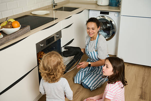 istock Mother Baking Croissants with Kids in a Bright Modern Kitchen 2215066198