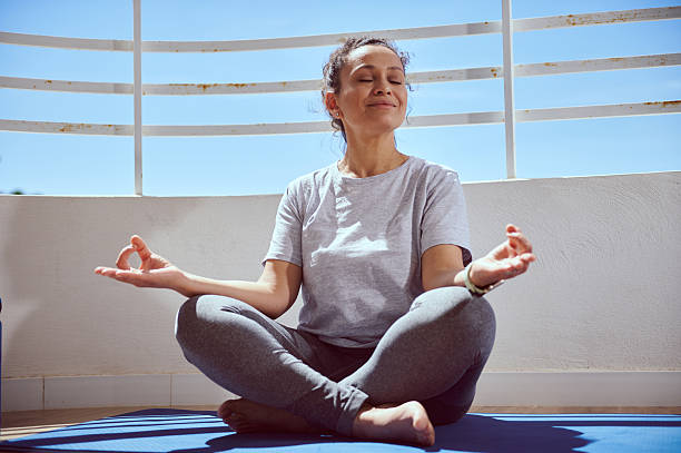 istock Woman Practicing Meditation Outdoors in Relaxed Setting for Mindful Wellness 2215066216