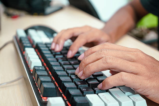 istock Close up of a male hands typing on a modern keyboard 2215066405