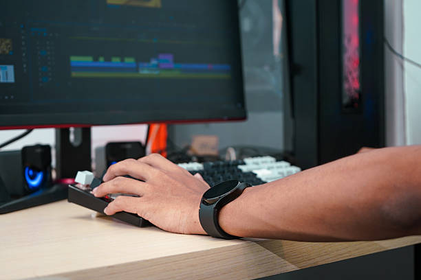 istock Close up of a male hands editing a video on a computer screen, focused on adjusting clips and editing tools 2215066415
