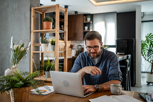 istock Focused freelancer working from home on laptop in modern apartment 2215070691
