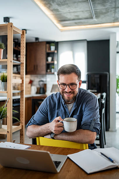 istock Freelancer enjoying a cup of coffee while working from home 2215071313