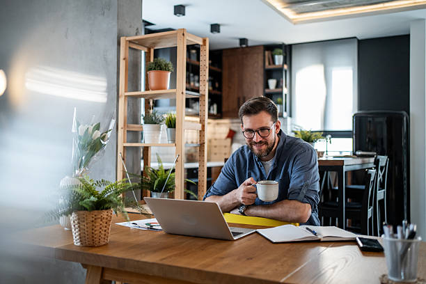istock Freelancer enjoying a cup of coffee while working from home 2215071320