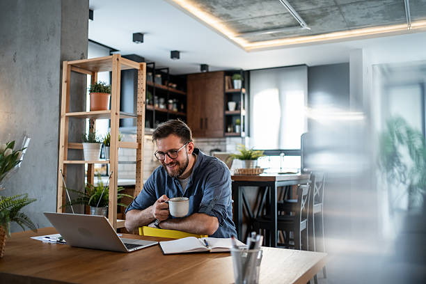 istock Freelancer enjoying a cup of coffee while working from home 2215071322