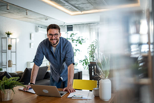 istock Freelancer smiling and working from home with laptop 2215071353