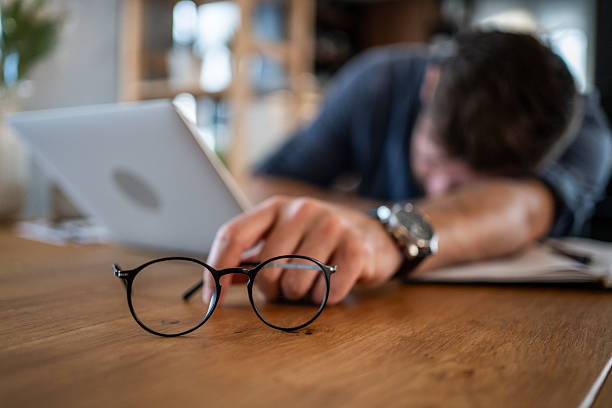 istock Exhausted businessman sleeping at his desk after long working hours 2215071388