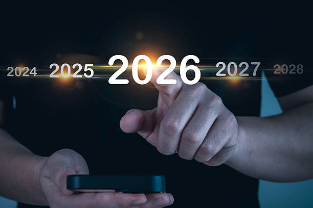 istock business man hand pointing on year 2026 with mobile smartphone, growth and development business, goal target, change from 2025 to 2026, strategy, investment, business planning, happy new year concept 2215071614