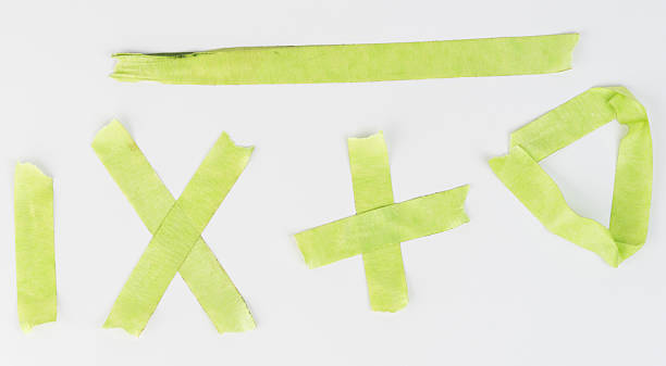 istock Green tape shapes arranged artistically on white surface in daylight 2215073084