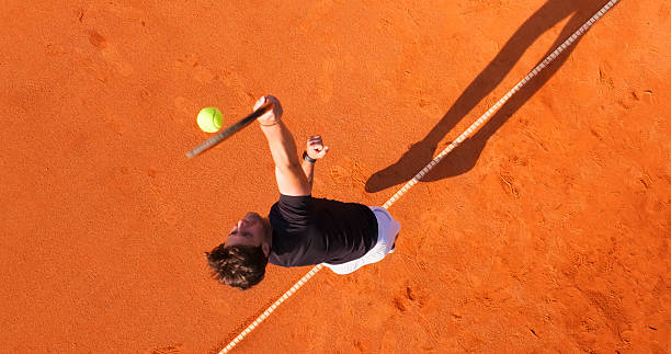 istock Tennis Player Serving on a Clay Court During a Sunny Day 2215075005