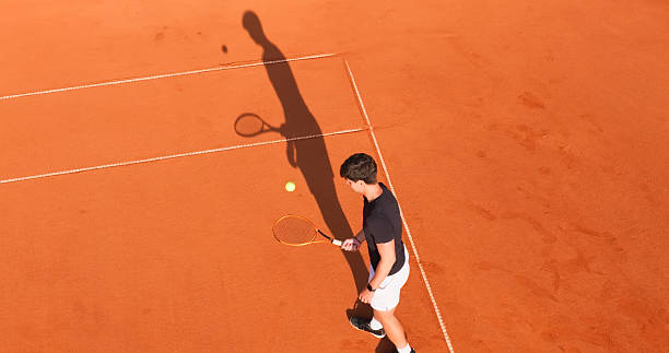 istock Young Tennis Player Practicing on a Clay Court Under the Summer Sun 2215075204