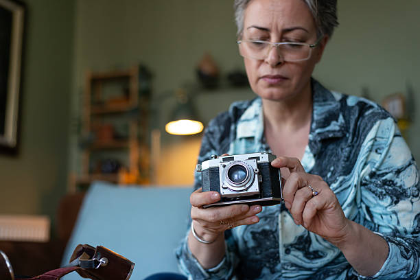 Mature woman is holding a camera