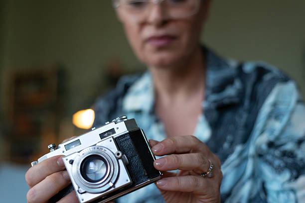Mature woman is holding a camera