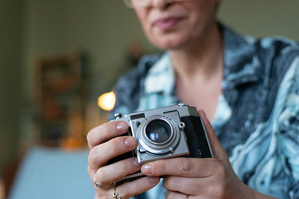 Mature woman is holding a camera